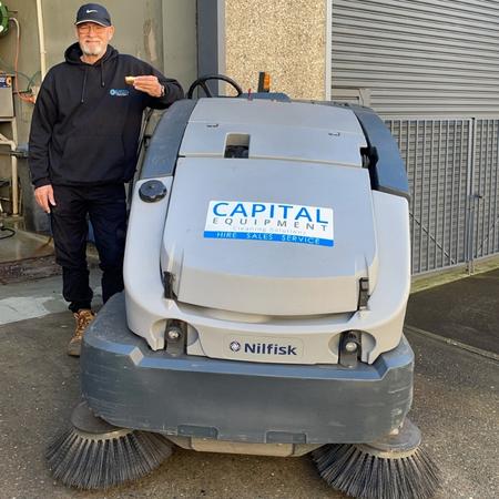 Capital Equipment Hire Staff Member next to CS7010 Sweeper Scrubber