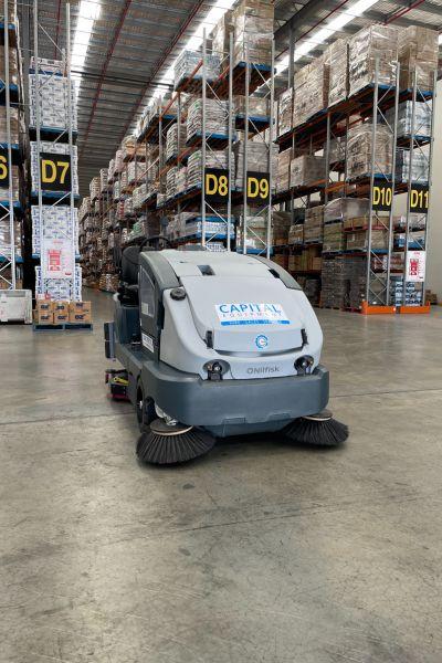 Nilfisk CS7010 Sweeper Scrubber Cleaning Warehouse Aisles